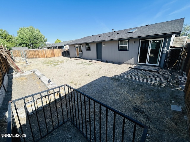 1442 Spooner Dr, Carson City, NV 89706 - rear view of property featuring a shingled roof, a fenced backyard, and crawl space