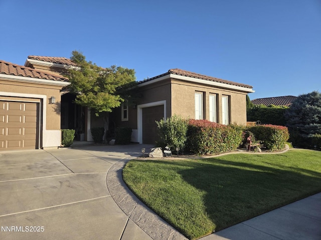 2580 Tuscan Way, Sparks, NV 89434 - mediterranean / spanish-style home featuring driveway, a garage, a tile roof, stucco siding, and a front lawn