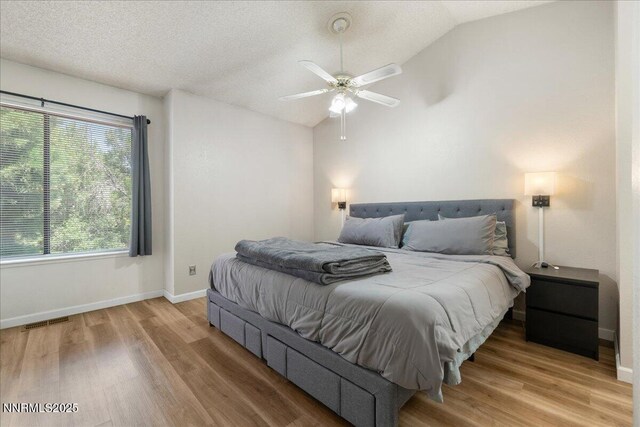 4318 Leeward Ln, Reno, NV 89502 - bedroom featuring vaulted ceiling, wood finished floors, multiple windows, and a ceiling fan