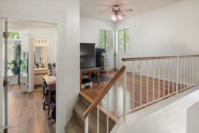 4318 Leeward Ln, Reno, NV 89502 - stairs featuring a ceiling fan, wood finished floors, and a textured ceiling