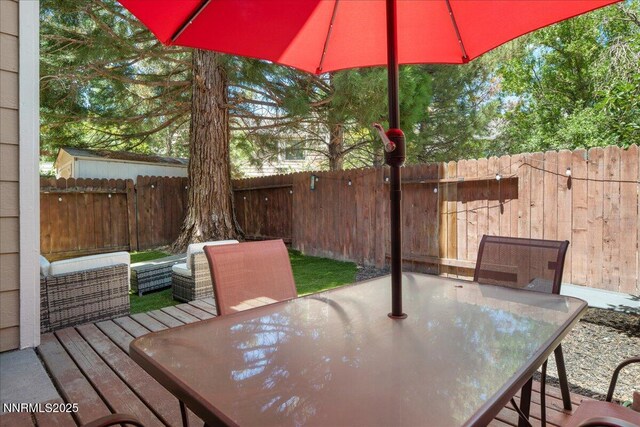 4318 Leeward Ln, Reno, NV 89502 - wooden terrace with outdoor dining area and a fenced backyard