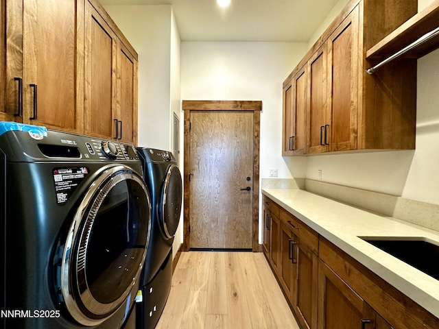 2935 Portrush Dr, Genoa, NV 89411 - laundry area featuring cabinet space, washer and clothes dryer, and light wood finished floors