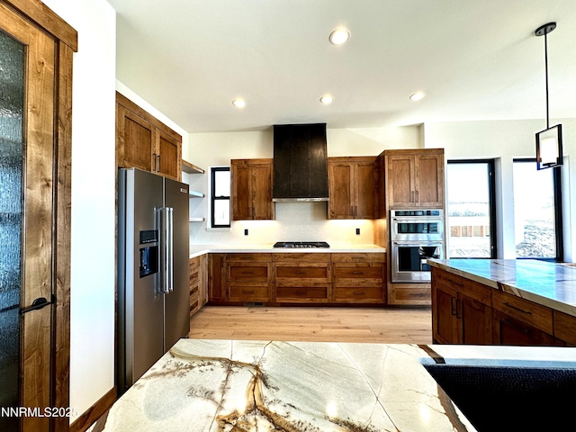 2935 Portrush Dr, Genoa, NV 89411 - kitchen featuring appliances with stainless steel finishes, extractor fan, open shelves, light wood-type flooring, and decorative light fixtures