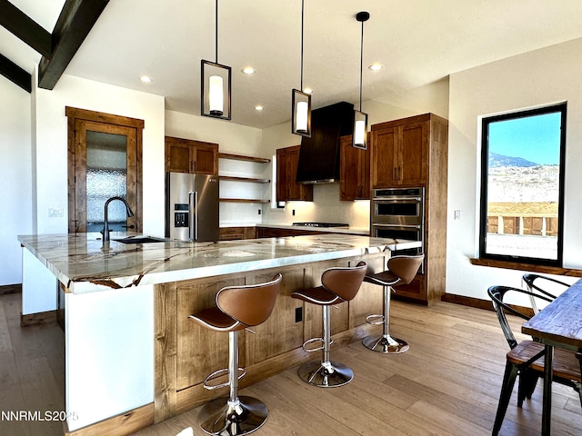 2935 Portrush Dr, Genoa, NV 89411 - kitchen with stainless steel appliances, range hood, open shelves, light wood finished floors, and recessed lighting