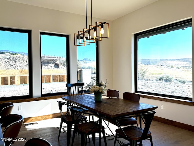 2935 Portrush Dr, Genoa, NV 89411 - dining space featuring wood finished floors, plenty of natural light, a chandelier, and a mountain view