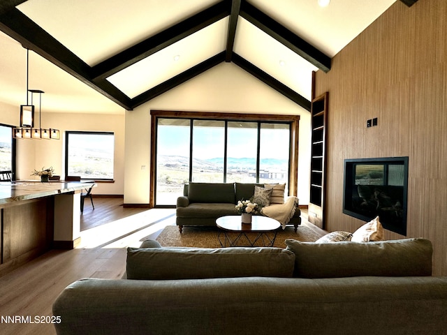 2935 Portrush Dr, Genoa, NV 89411 - living area with wood finished floors, beam ceiling, built in shelves, high vaulted ceiling, and a mountain view