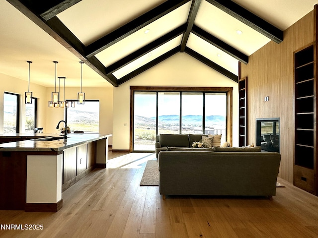 2935 Portrush Dr, Genoa, NV 89411 - living room featuring healthy amount of natural light, wood-type flooring, built in shelves, and a mountain view