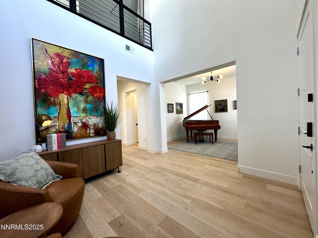 5454 Side Saddle Trl, Reno, NV 89511 - foyer entrance with light wood-style flooring, a chandelier, and a high ceiling