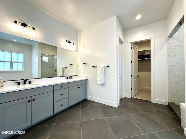 5454 Side Saddle Trl, Reno, NV 89511 - bathroom featuring tiled shower, double vanity, tile patterned floors, a spacious closet, and recessed lighting