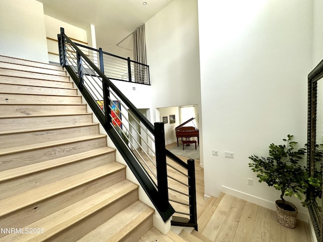 5454 Side Saddle Trl, Reno, NV 89511 - staircase featuring wood finished floors and a towering ceiling