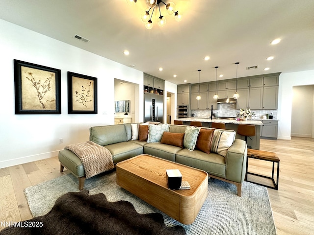 5454 Side Saddle Trl, Reno, NV 89511 - living room featuring light wood finished floors, recessed lighting, and a chandelier