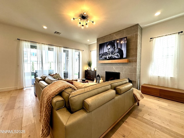 5454 Side Saddle Trl, Reno, NV 89511 - living room with light wood-style flooring, a tile fireplace, and recessed lighting