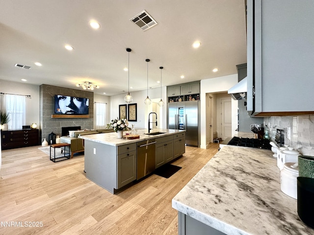5454 Side Saddle Trl, Reno, NV 89511 - kitchen with stainless steel appliances, light wood-style floors, gray cabinets, recessed lighting, and open floor plan