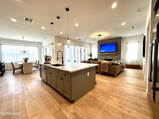 5454 Side Saddle Trl, Reno, NV 89511 - kitchen featuring gray cabinets, dishwasher, light wood-type flooring, recessed lighting, and light stone counters
