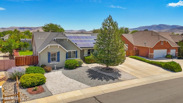 164 Oakridge Dr, Dayton, NV 89403 - traditional-style house with a mountain view, stucco siding, roof mounted solar panels, an attached garage, and driveway