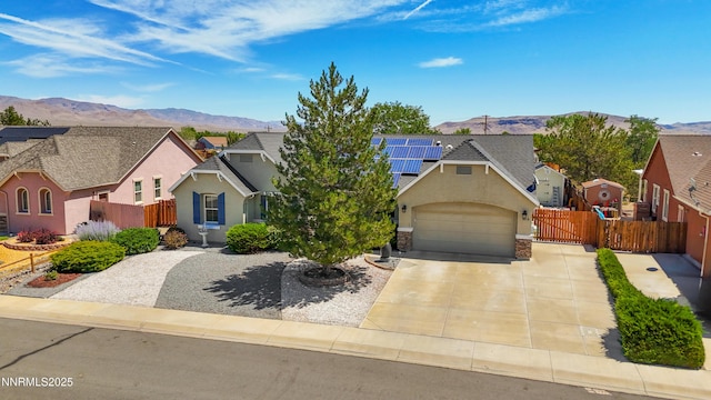 164 Oakridge Dr, Dayton, NV 89403 - view of front of home with a mountain view, solar panels, stucco siding, and driveway