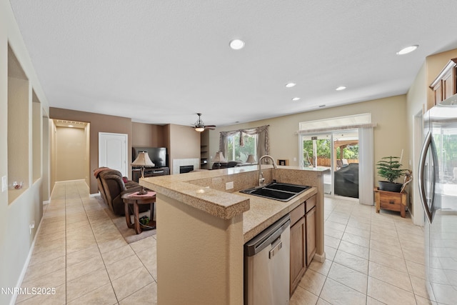 164 Oakridge Dr, Dayton, NV 89403 - kitchen with appliances with stainless steel finishes, a center island with sink, light tile patterned flooring, a ceiling fan, and light countertops