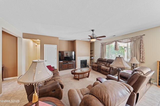 164 Oakridge Dr, Dayton, NV 89403 - living area with ceiling fan, a textured ceiling, a fireplace, and light tile patterned flooring