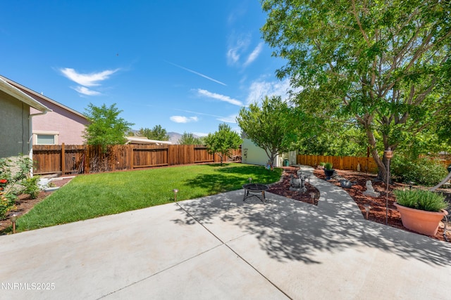 164 Oakridge Dr, Dayton, NV 89403 - fenced backyard with a patio area, a fire pit, and a storage unit