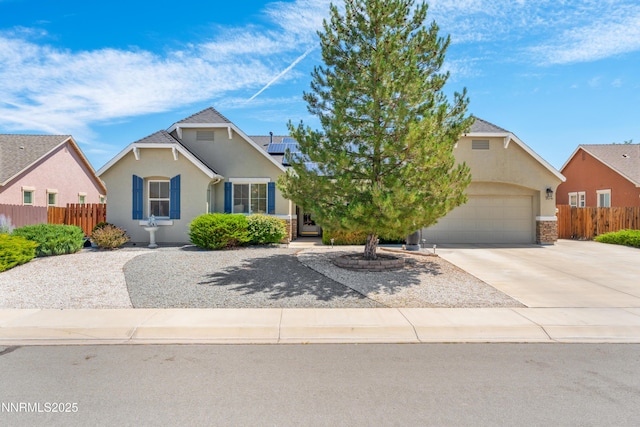 164 Oakridge Dr, Dayton, NV 89403 - view of front of house with an attached garage, driveway, stucco siding, and solar panels