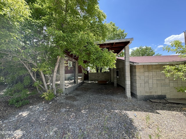 4 3rd St, Mcgill, NV 89318 - view of home's exterior featuring concrete block siding, a carport, and driveway