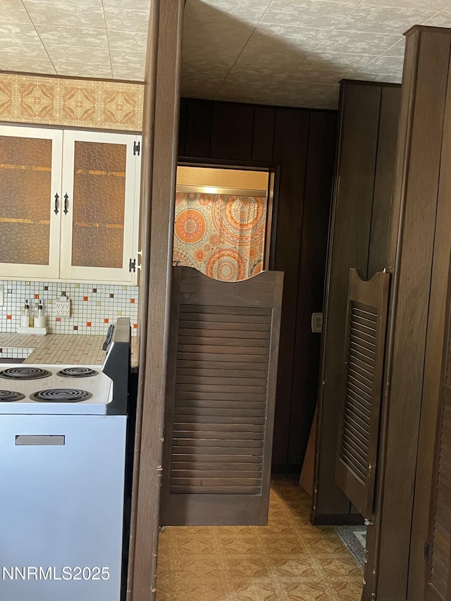 4 3rd St, Mcgill, NV 89318 - kitchen view of backsplash, glass insert cabinets, and light floors