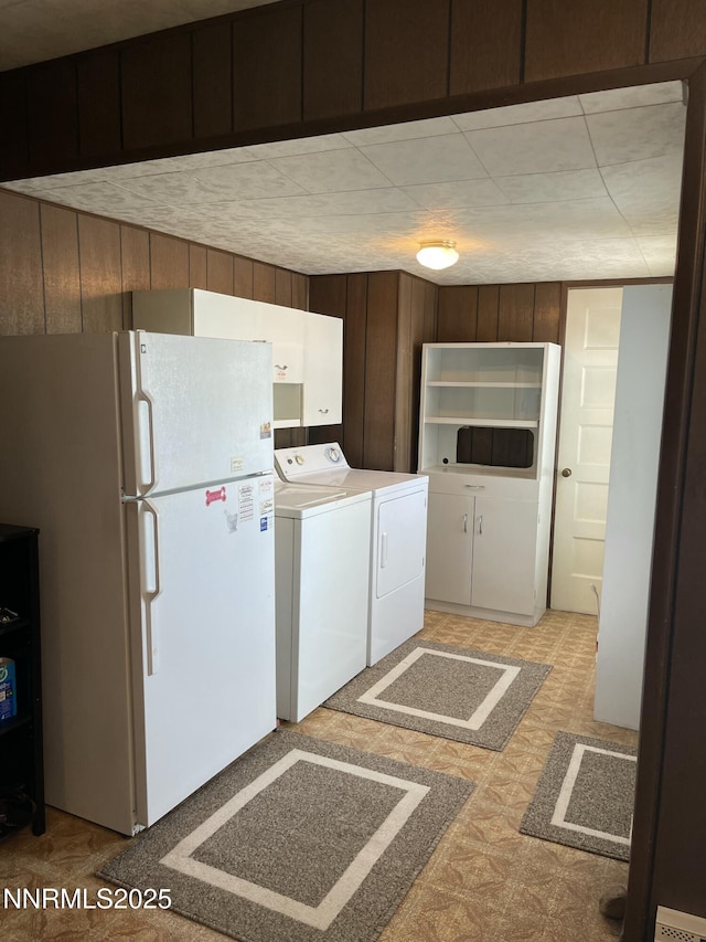 4 3rd St, Mcgill, NV 89318 - kitchen with freestanding refrigerator, light floors, and washer and dryer