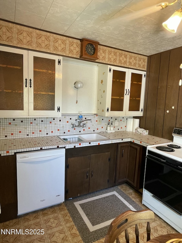 4 3rd St, Mcgill, NV 89318 - kitchen featuring white appliances, light countertops, tasteful backsplash, glass insert cabinets, and dark brown cabinets