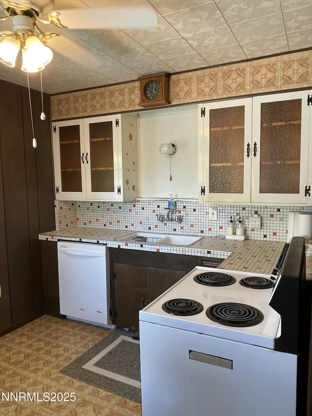 4 3rd St, Mcgill, NV 89318 - kitchen featuring white appliances, tasteful backsplash, a ceiling fan, and glass insert cabinets