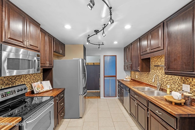 3200 Vickie Ln, Sparks, NV 89431 - kitchen with stainless steel appliances, butcher block countertops, dark brown cabinetry, decorative backsplash, and recessed lighting