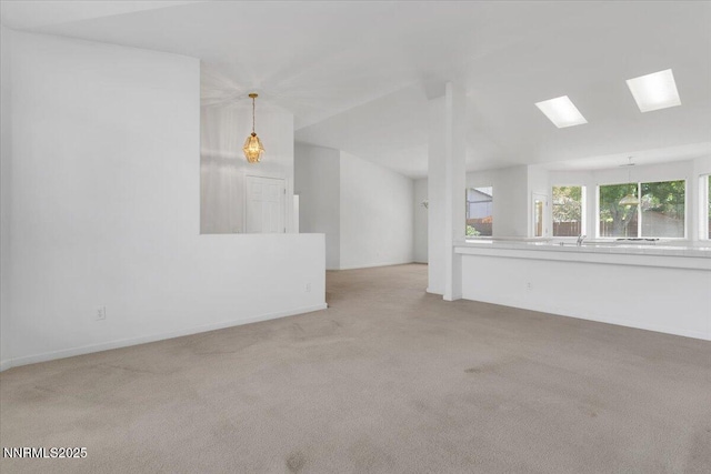 1797 Lantana Dr, Minden, NV 89423 - unfurnished living room with carpet flooring, a skylight, and lofted ceiling