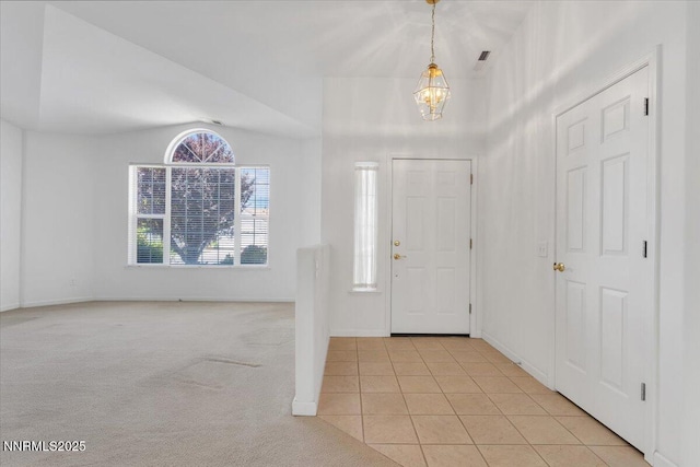 1797 Lantana Dr, Minden, NV 89423 - entryway with a chandelier, light tile patterned floors, and light colored carpet