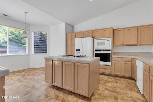 1797 Lantana Dr, Minden, NV 89423 - kitchen with white appliances, tile counters, stone finish flooring, light brown cabinetry, and a kitchen island