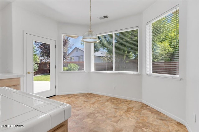 1797 Lantana Dr, Minden, NV 89423 - unfurnished dining area featuring stone finish floors and baseboards