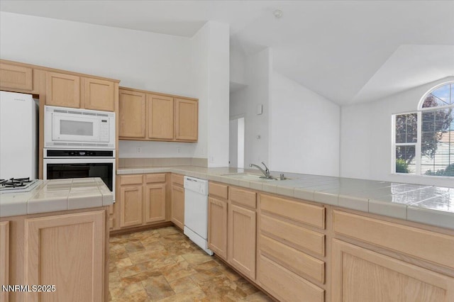 1797 Lantana Dr, Minden, NV 89423 - kitchen featuring white appliances, light brown cabinetry, tile countertops, lofted ceiling, and stone finish floors
