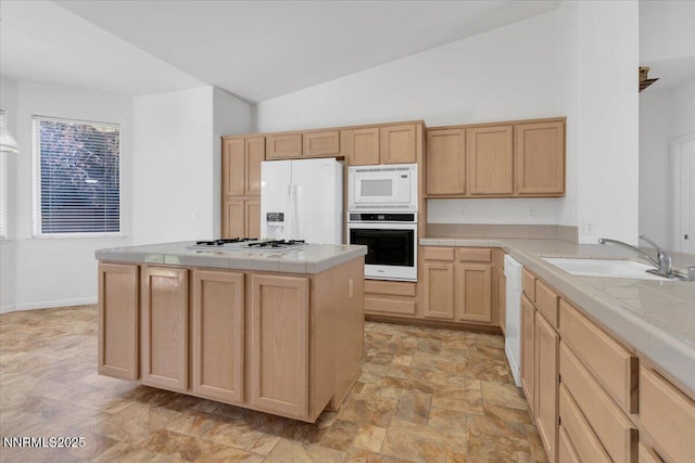 1797 Lantana Dr, Minden, NV 89423 - kitchen with white appliances, tile counters, light brown cabinetry, stone finish floors, and vaulted ceiling