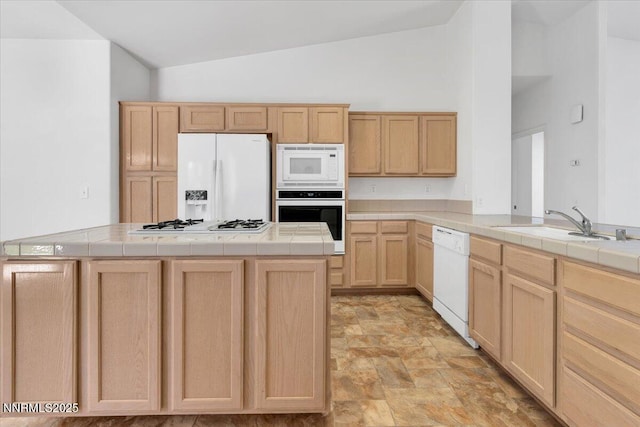 1797 Lantana Dr, Minden, NV 89423 - kitchen featuring white appliances, light brown cabinets, tile counters, stone finish floors, and high vaulted ceiling