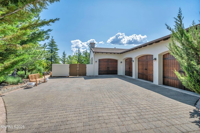 186 Carleton Ct, Reno, NV 89511 - garage featuring a gate and decorative driveway