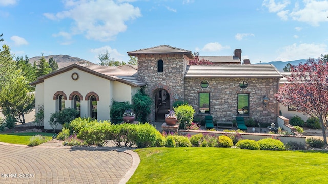 186 Carleton Ct, Reno, NV 89511 - mediterranean / spanish house with a mountain view, a tile roof, a front yard, and stucco siding