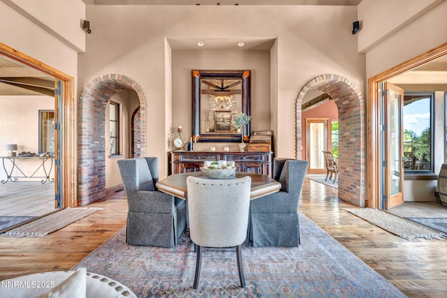 186 Carleton Ct, Reno, NV 89511 - dining room featuring arched walkways, hardwood / wood-style floors, and brick wall