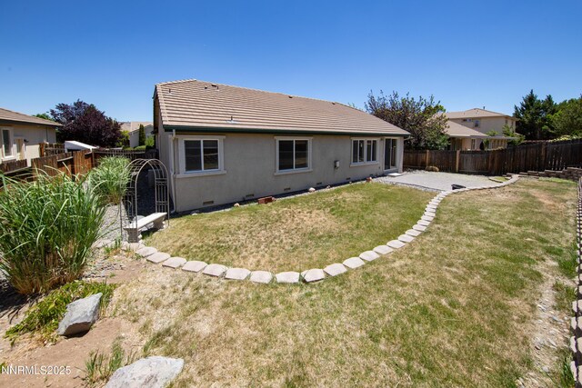 5287 Vidette Meadows Dr, Sparks, NV 89436 - back of house with a fenced backyard, stucco siding, a tiled roof, a patio, and crawl space