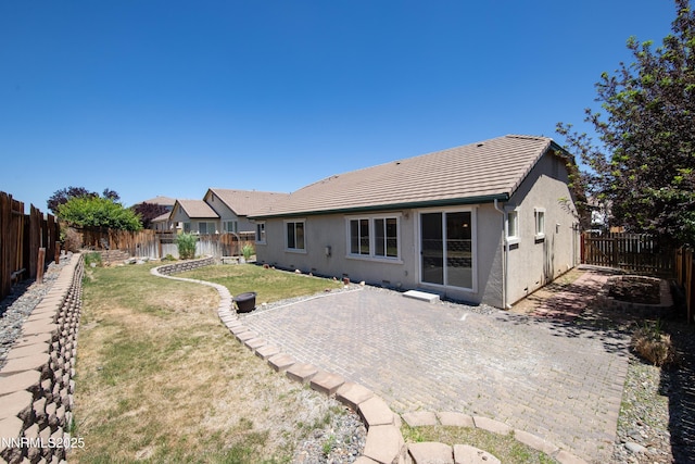 5287 Vidette Meadows Dr, Sparks, NV 89436 - back of property featuring a tiled roof, stucco siding, a fenced backyard, and a patio area