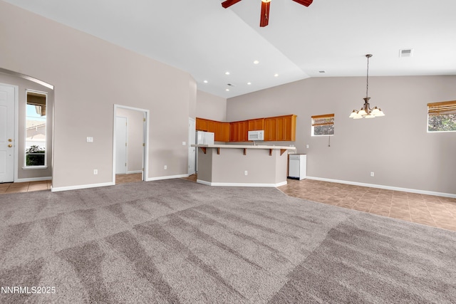5287 Vidette Meadows Dr, Sparks, NV 89436 - unfurnished living room featuring ceiling fan, a chandelier, light tile patterned floors, arched walkways, and light carpet