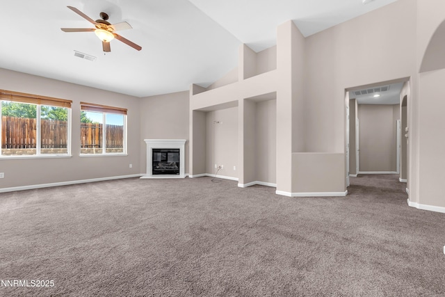 5287 Vidette Meadows Dr, Sparks, NV 89436 - unfurnished living room with carpet, a ceiling fan, a glass covered fireplace, and high vaulted ceiling