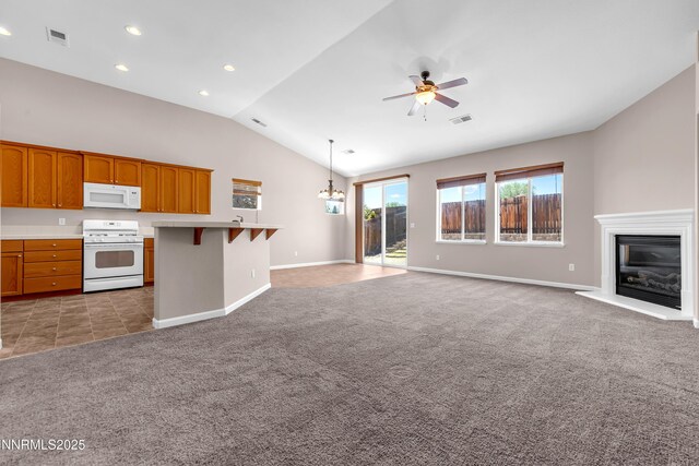 5287 Vidette Meadows Dr, Sparks, NV 89436 - unfurnished living room with light carpet, ceiling fan, vaulted ceiling, a glass covered fireplace, and recessed lighting