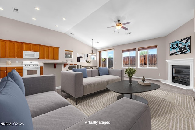 5287 Vidette Meadows Dr, Sparks, NV 89436 - living room featuring a ceiling fan, vaulted ceiling, recessed lighting, a glass covered fireplace, and carpet floors