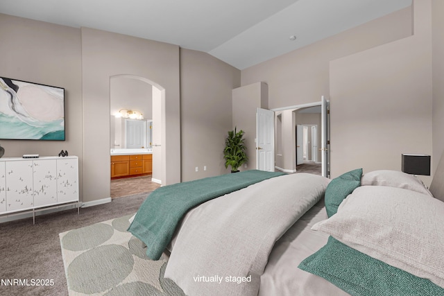5287 Vidette Meadows Dr, Sparks, NV 89436 - bedroom featuring carpet, arched walkways, lofted ceiling, and connected bathroom