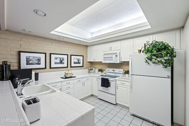 1200 Riverside Dr # 1232, Reno, NV 89503 - kitchen featuring white appliances, tile counters, and white cabinets
