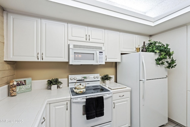 1200 Riverside Dr # 1232, Reno, NV 89503 - kitchen with white appliances, tile counters, and white cabinets