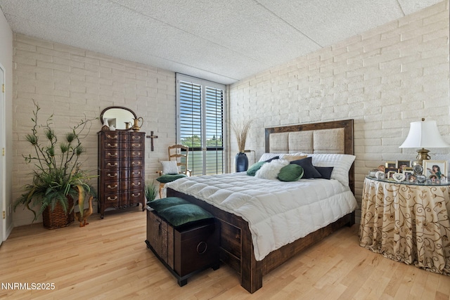 1200 Riverside Dr # 1232, Reno, NV 89503 - bedroom featuring light wood-style floors, expansive windows, and brick wall